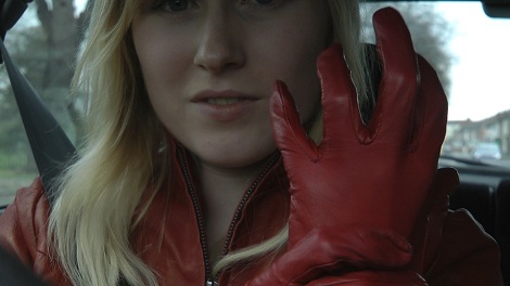 Girl-driving-car-in-red-leather-gloves-and-jacket