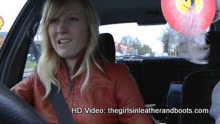 Girl-driving-car-in-red-leather-gloves-and-jacket