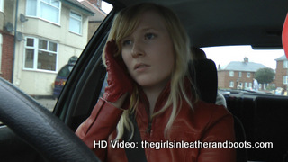 Girl-driving-car-in-red-leather-gloves-and-jacket