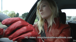 Girl-driving-car-in-red-leather-gloves-and-jacket