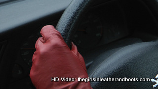 Girl-driving-car-in-red-leather-gloves-and-jacket