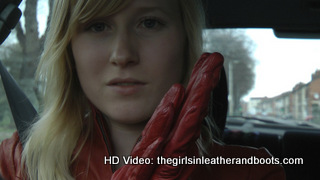 Girl-driving-car-in-red-leather-gloves-and-jacket