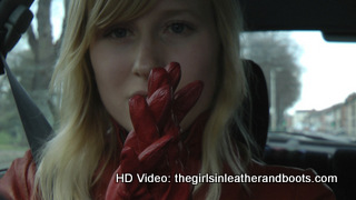 Girl-driving-car-in-red-leather-gloves-and-jacket