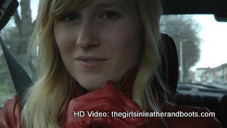 Girl-driving-car-in-red-leather-gloves-and-jacket