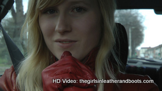 Girl-driving-car-in-red-leather-gloves-and-jacket