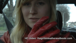 Girl-driving-car-in-red-leather-gloves-and-jacket