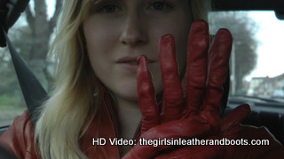 Girl-driving-car-in-red-leather-gloves-and-jacket