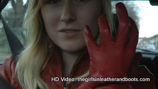 Girl-driving-car-in-red-leather-gloves-and-jacket