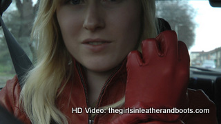 Girl-driving-car-in-red-leather-gloves-and-jacket