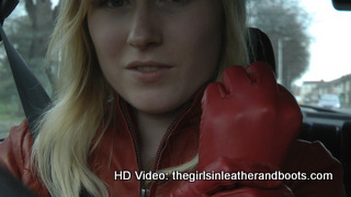 Girl-driving-car-in-red-leather-gloves-and-jacket