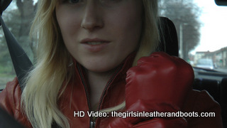 Girl-driving-car-in-red-leather-gloves-and-jacket