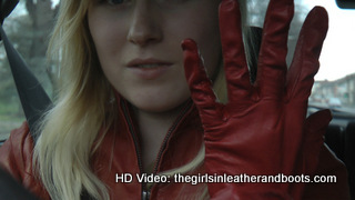 Girl-driving-car-in-red-leather-gloves-and-jacket