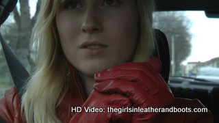 Girl-driving-car-in-red-leather-gloves-and-jacket