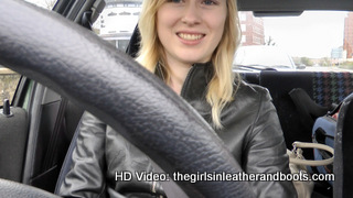 Girl-driving-car-in-red-leather-gloves-and-jacket